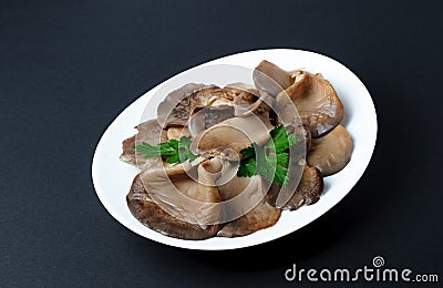 Marinated oyster mushrooms laid on a white plate Stock Photo