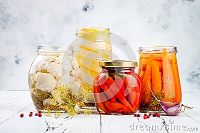 Marinated pickles variety preserving jars. Homemade cauliflower, squash, carrots, red chili peppers pickles. Fermented food Stock Photo