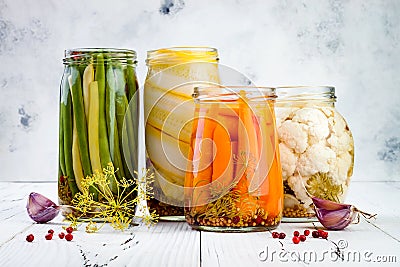 Marinated pickles variety preserving jars. Homemade green beans, squash, carrots, cauliflower pickles. Fermented food Stock Photo