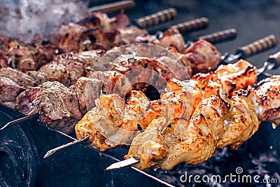 Marinated shashlik preparing on a barbecue grill over charcoal. Shashlik or Shish kebab popular in Eastern Europe. Stock Photo