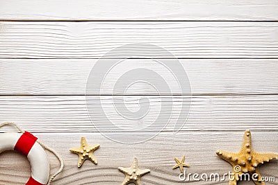 Marine background - starfish, lifebuoy and beach sand on woods Stock Photo