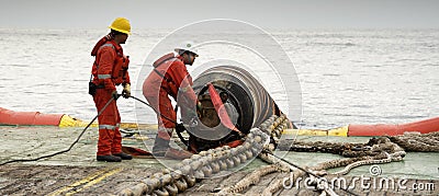 Marine crew doing hose connection operation Editorial Stock Photo