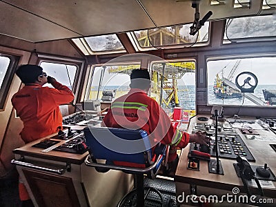 Marine crew maneuver vessel Editorial Stock Photo