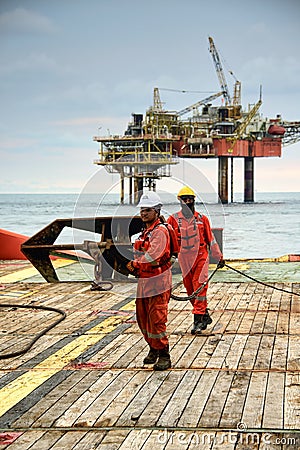 Marine crew pulling wire for anchor handling operation Editorial Stock Photo