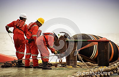 Marine crew doing hose connection operation Editorial Stock Photo