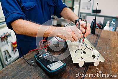 Marine electrical engineer officer in engine control room ECR. He works in workshop Stock Photo