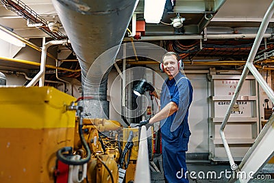 Marine engineer officer controlling vessel enginesand propulsion in engine control room ECR Stock Photo