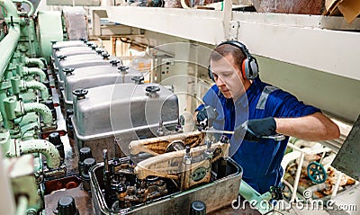 Marine engineer officer controlling vessel enginesand propulsion in engine control room ECR Stock Photo