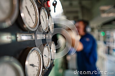 Marine engineer officer controlling vessel enginesand propulsion in engine control room ECR Stock Photo