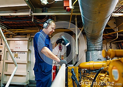 Marine engineer officer controlling vessel enginesand propulsion in engine control room ECR Stock Photo