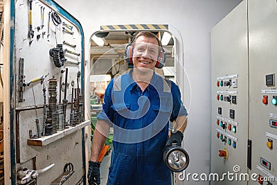 Marine engineer officer controlling vessel enginesand propulsion in engine control room ECR Stock Photo