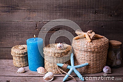 Marine items and blue candle on aged wooden background. Stock Photo