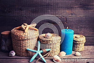 Marine items and blue candle on aged wooden background. Stock Photo