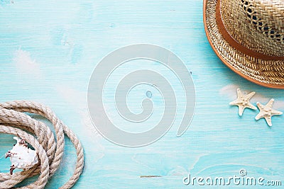 Marine rope and straw hat are on the blue wooden background Stock Photo