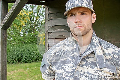 Marine, soldier in his army fatigues stands to attention at military base Stock Photo