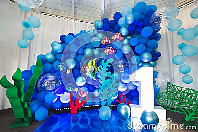 Marine-style decor of balloons, fish, and corals for the birthday photo zone Stock Photo