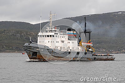 The marine tugboat sails along the Kola Bay water area Editorial Stock Photo