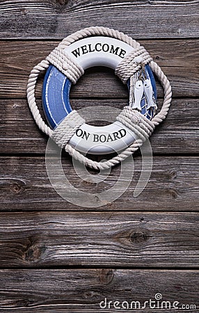 Maritime decoration - life belt on wooden background - concept Stock Photo