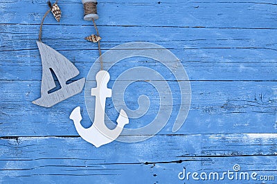 Maritime Decoration with shells, starfish, sailing ship, fishing net on blue drift wood Stock Photo