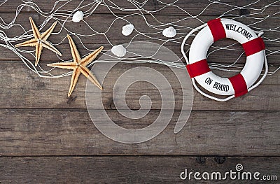 Maritime Decoration with shells, starfish, sailing ship, fishing net on blue drift wood Stock Photo