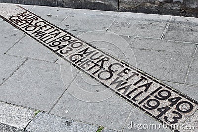 Marker of the Warsaw Ghetto wall on the street Editorial Stock Photo