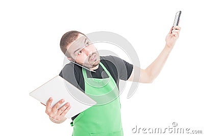 Market employee being busy multitasking with tablet and phones Stock Photo