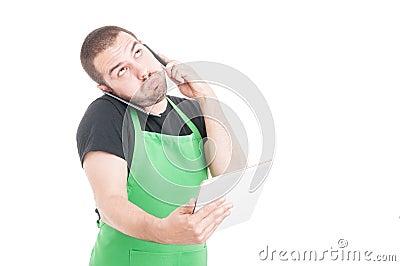 Market employee being busy multitasking with tablet and phones Stock Photo