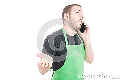 Market employee explaining something on phone Stock Photo