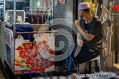 Market seller in Muslim Quarter in Xian Editorial Stock Photo