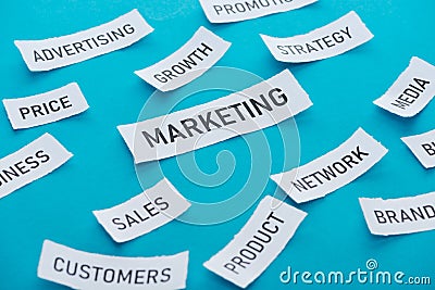 Marketing components on pieces of paper on blue . Stock Photo