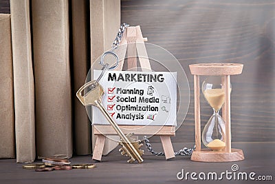 Marketing concept with icons. Sandglass, hourglass or egg timer on wooden table Stock Photo