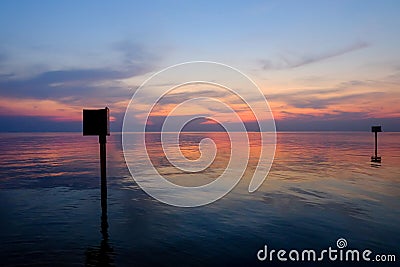 Marking steel pole in the sea, twilight time Stock Photo