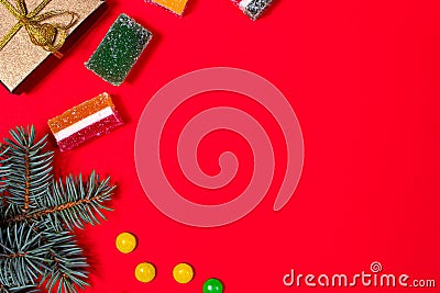 Marmalade candy and lollipops on a red New Year`s background. Banner for confectionery and candy store. With place for text Stock Photo