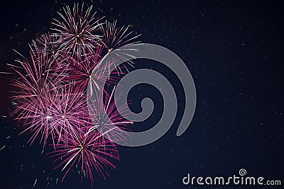 Maroon red pink celebration fireworks over night sky Stock Photo