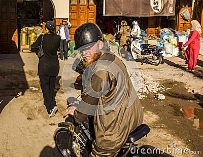 Marrakech; may, 14, 2016: angry Moroccan man riding a motorcycle down a street in Marrakech in Morocco Editorial Stock Photo