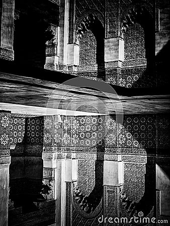 Marrakech, MOROCCO - February 10, 2012 - Courtyard carvings water reflexions in Ben Youssef Madrasa Editorial Stock Photo