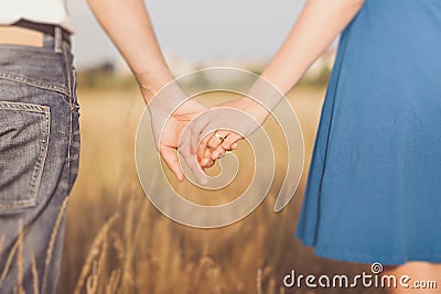 Married couple holding hands at sunset Stock Photo