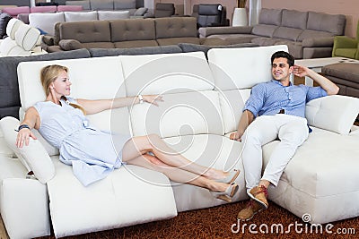 Married couple testing new sofa-transformer Stock Photo