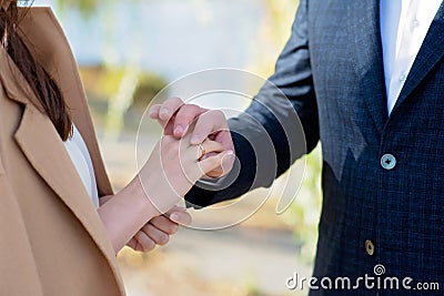 Marry me today and every day, hands of a wedding heterosexual couple. The groom put the ring on the finger of his beautiful wife. Stock Photo