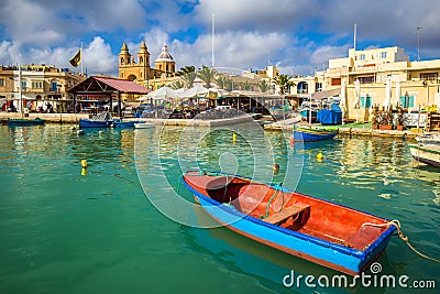 Marsaxlokk, Malta - Traditional colorful maltese Luzzu fisherboat at the old village of Marsaxlokk Editorial Stock Photo