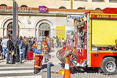 Marseille, France, 08/10/2019: Firefighters at the city`s railway station. Evacuated passengers are waiting on the street Editorial Stock Photo