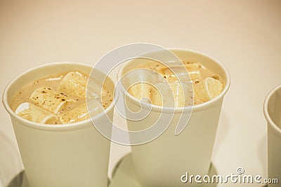 Two cups of hot cocoa and snow-white marshmallows floating in it Stock Photo