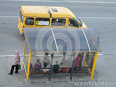 A 'marshrutka' routed taxi and bus stop with people Editorial Stock Photo