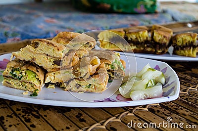 MARTABAK TELUR - stuffed pancake or pan-fried bread Indo-style on a plate, close-up with TERANG BULAN Stock Photo