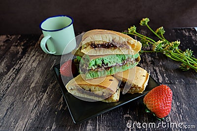 Martabak Terang Bulan, sweet indonesian snack, thick pancake filled with chocolate sprinkles and grated cheese Stock Photo