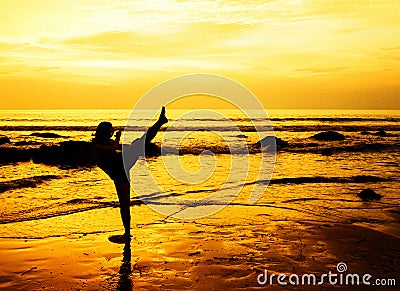 Martial arts woman on the beach Stock Photo