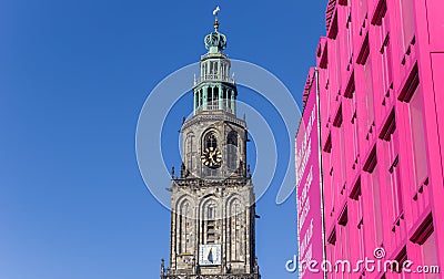 Martini tower and pink building in the center of Groningen Editorial Stock Photo