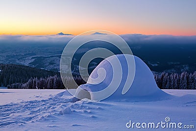 Marvelous huge white snowy hut, igloo the house of tourist is standing on high mountain far away from the human eye. Stock Photo