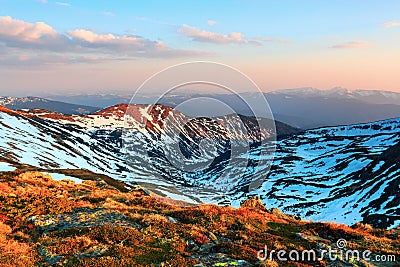 Marvelous view from the lawn of the enchanting sunrise, incredible sky, mountains in snow. Stock Photo