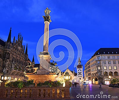 Mary's Square illuminated at dusk with the Old City Hall on the background in Munich Stock Photo